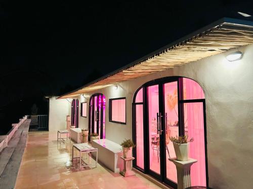 a row of windows with pink lighting on a building at Pillow Inn Ubud in Ubud