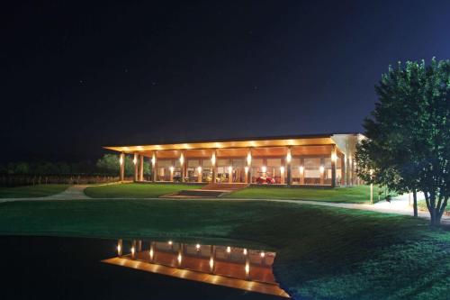 a large building with lights in the night at Ambassadori Kachreti Golf Resort in Kachretʼi