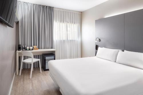 莫列特－德爾巴列斯的住宿－B&B HOTEL Barcelona Mollet，配有一张床和一张书桌的酒店客房