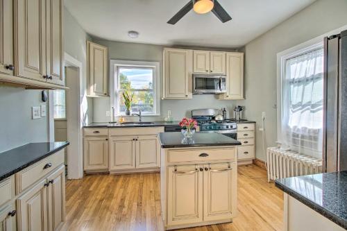 a kitchen with white cabinets and a ceiling fan at Front Royal Retreat about 1 Mi to National Park! in Front Royal