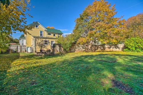 a large yard with a yellow house at Front Royal Retreat about 1 Mi to National Park! in Front Royal