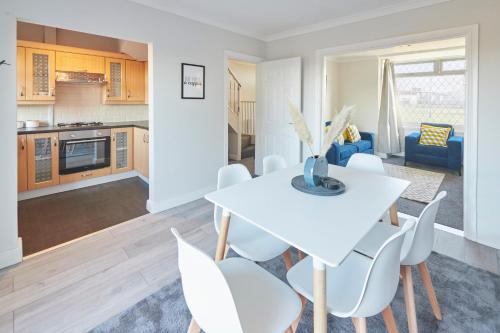 a kitchen and living room with a white table and chairs at Host & Stay - Armitage Road in Redcar