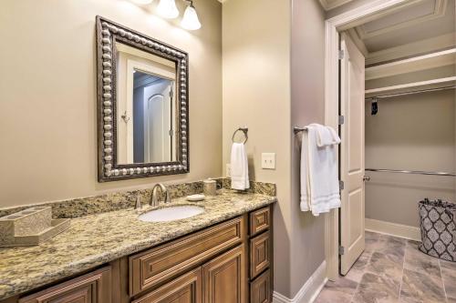 a bathroom with a sink and a mirror at Diamondhead Condo - Marina, Pool Access and Golfing! in Diamondhead
