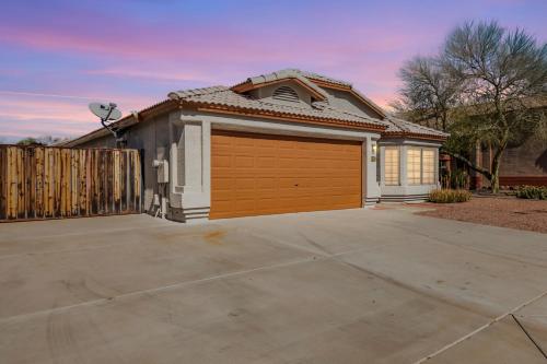 a house with a large garage in a driveway at Emile Zola Peoria home in Peoria