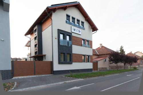 a building with a sign on the side of a street at PontJó Apartman Miskolc in Miskolc