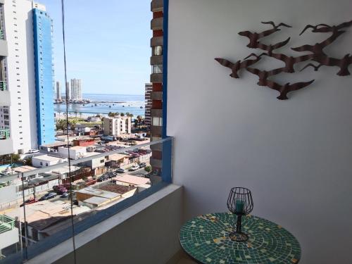 a table in a room with a view of a city at Departamento sector Cavancha in Iquique