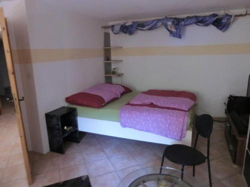 a room with two beds and a table and chairs at Urlaub am Inn in Wasserburg am Inn