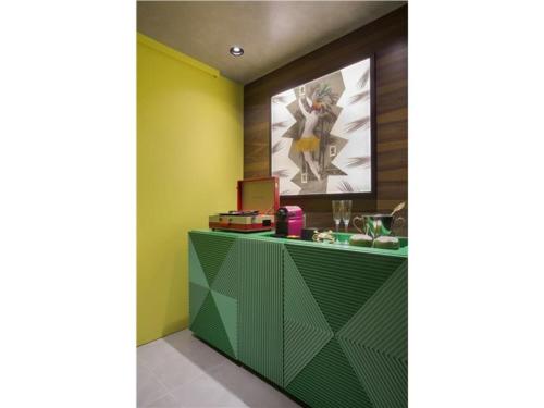 a green counter in a room with a picture on the wall at Yoo2 Rio de Janeiro, Tapestry Collection by Hilton in Rio de Janeiro