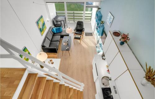 an overhead view of a living room with a staircase at 3 Bedroom Cozy Apartment In Ringkøbing in Ringkøbing