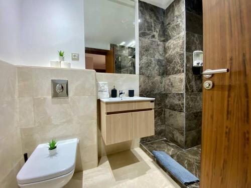 a bathroom with a toilet and a sink and a shower at Charming Top Floor Bourgogne - By AppartAli in Casablanca