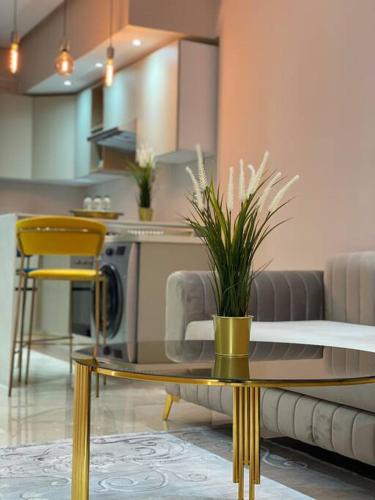 a living room with a table and yellow chairs at Charming Top Floor Bourgogne - By AppartAli in Casablanca