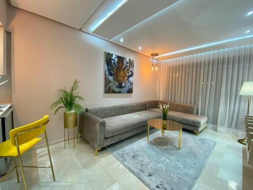 a living room with a couch and a table at Charming Top Floor Bourgogne - By AppartAli in Casablanca
