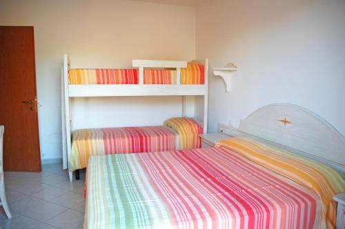 A bed or beds in a room at Baia Fiorita