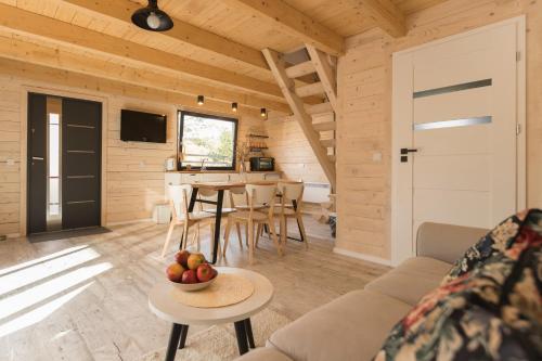 a room with a couch and a table with a bowl of fruit at Ostoja Notecka in Wieleń