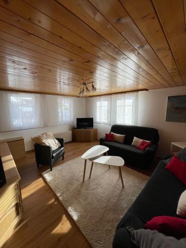 a living room with a couch and a table at Moritzhaus in Grächen