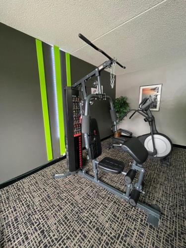a room with a gym with a wall with green stripes at Wingate by Wyndham Lake George in Lake George