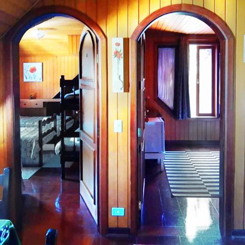 an open door to a room with a bedroom at Pousada Casa dos Sonhos in Campos do Jordão
