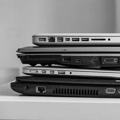 a stack of three laptops stacked on top of each other at 3 Bedroom Home in East Ham in London