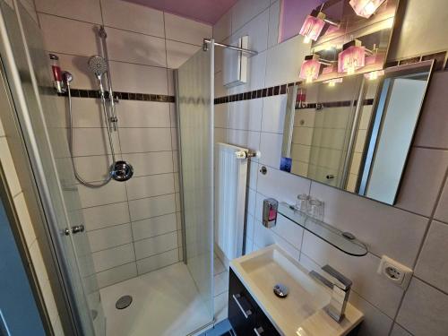 a bathroom with a shower and a sink at Hotel Leonhardihof in Bad Tölz