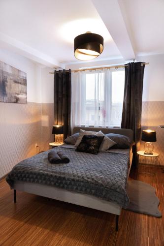 a bedroom with a bed with a large window at ClickTheFlat Piękna Center Apart Rooms in Warsaw