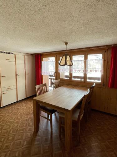 a dining room with a wooden table and chairs at Moritzhaus in Grächen