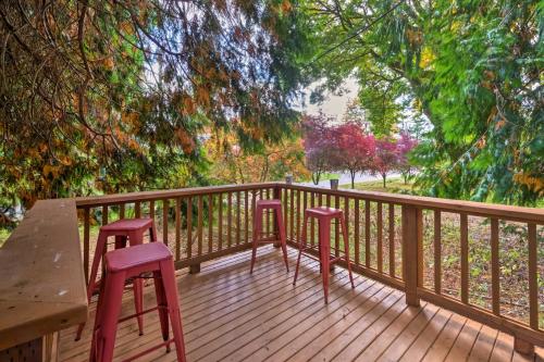 two chairs and a table on a wooden deck at House with Deck on Whidbey Island, 1 Mi from Shore! in Clinton
