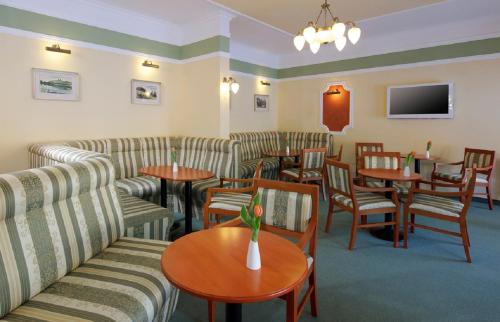 フランチシュコヴィ・ラーズニェにあるSavoy Spa & Kurhotelのソファ、テーブル、椅子が備わる待合室