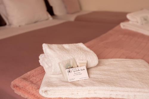 a pile of towels sitting on top of a bed at Granello Suite Central in Genova