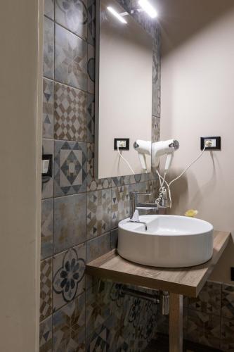 a bathroom with a sink and a mirror at Granello Suite Central in Genova