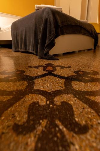 a rug on the floor of a bedroom with a bed at Granello Suite Central in Genova