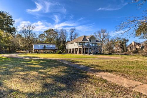 a large house on a grass field with a driveway at Coden Vacation Rental with Bay Access! in Coden