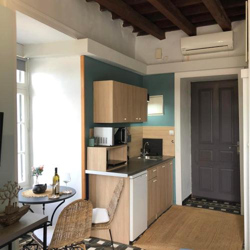 a small kitchen with a table and a table and chairs at Old Port - Bellavista Studio in Chania