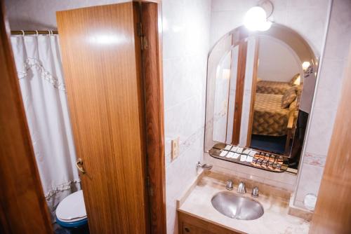 a bathroom with a sink and a mirror at Hotel Pacífico in Mendoza