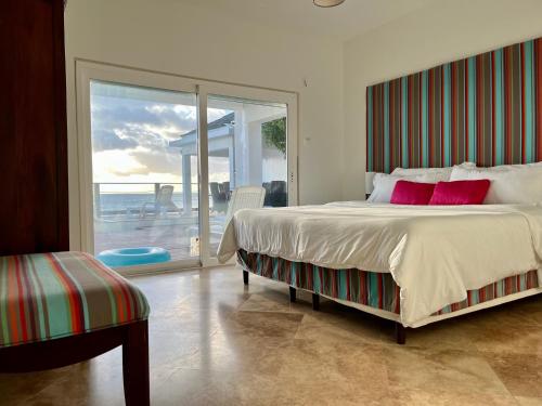 a bedroom with a bed with a view of the ocean at Sunset Surf Villa Beacon Hill in Simpson Bay