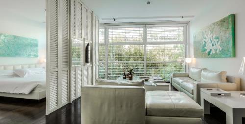 a living room with a couch and a bed at Magna Pars l'Hotel à Parfum, Small Luxury Hotels of the World in Milan