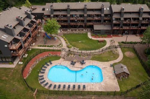 an aerial view of an apartment complex with a swimming pool at Caribou Highlands Lodge in Lutsen