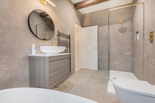 a bathroom with a sink and a mirror at Willow, a luxury rural retreat in Staveley