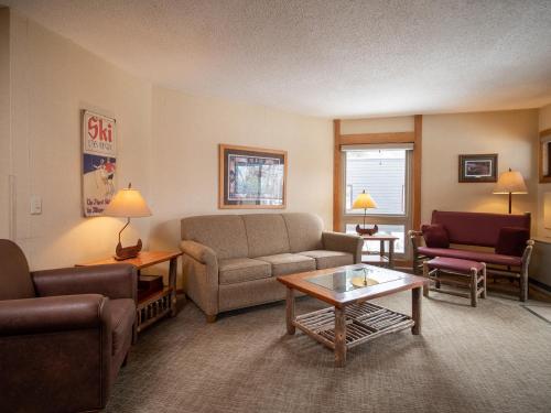 a living room with a couch and a table at Caribou Highlands Lodge in Lutsen