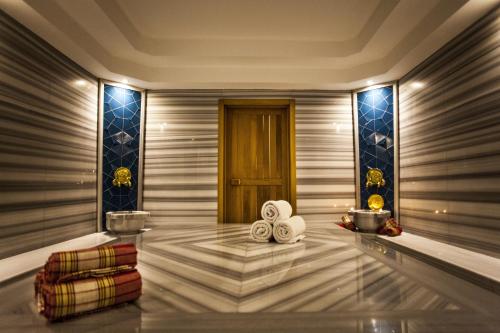 a lobby with a door and a table with towels at Surmeli Istanbul Hotel in Istanbul