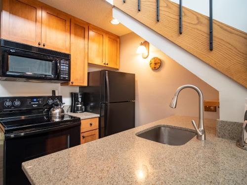 a kitchen with a sink and a refrigerator at Caribou Highlands Lodge in Lutsen