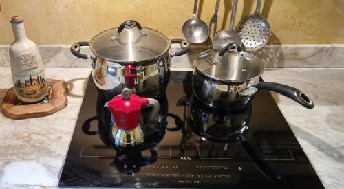 two pots and pans sitting on top of a stove at Podere Piandicava in Castelnuovo di Val di Cecina