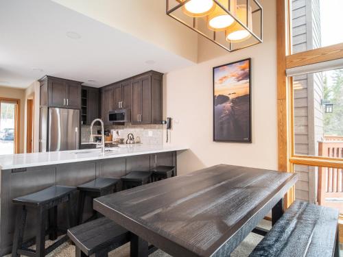 a kitchen with a large wooden table and benches at Caribou Highlands Lodge in Lutsen