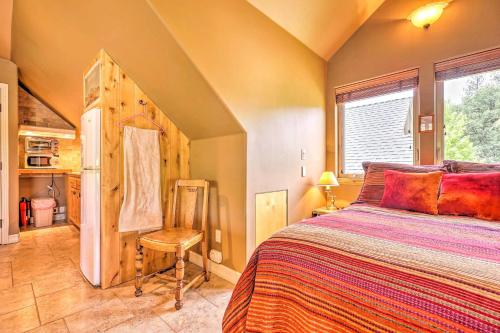 a bedroom with a bed and a chair and a window at Romantic YosemiteandBass Lake Retreat with Mtn Views! in North Fork