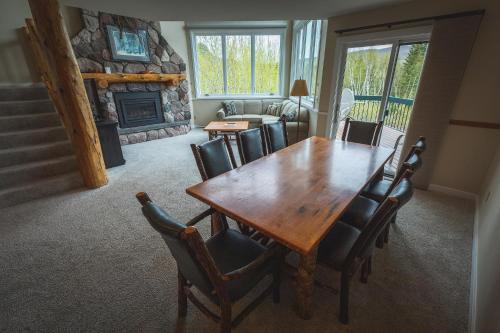 a dining room with a wooden table and chairs at Caribou Highlands Lodge in Lutsen
