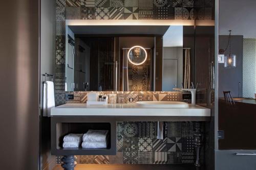 a bathroom with a sink and a large mirror at W Philadelphia in Philadelphia