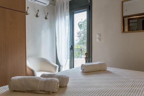 a bedroom with a bed with two towels on it at Sant'Agata in Lixouri