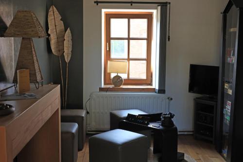 a living room with a table and a window at A la Caravelle in Chaineux