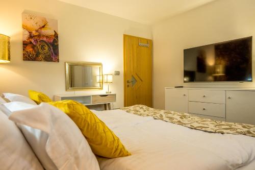 a bedroom with a bed with a television on the wall at Relax & Beautiful View in Slovenj Gradec
