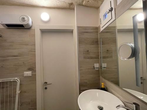 a bathroom with a sink and a mirror at Romantico Monolocale nel cuore di Otranto con garage in Otranto