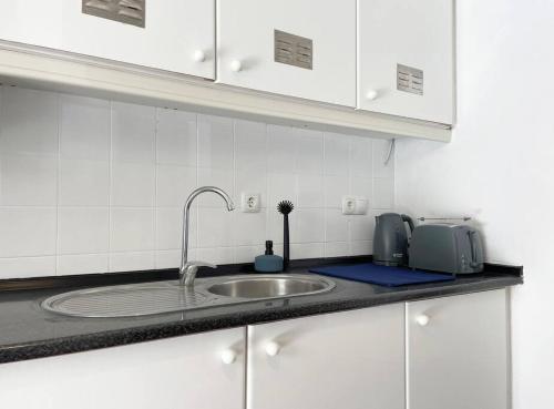 a kitchen counter top with a sink and a counter top at Villas Pedroso - Villa Palmira in Cascais